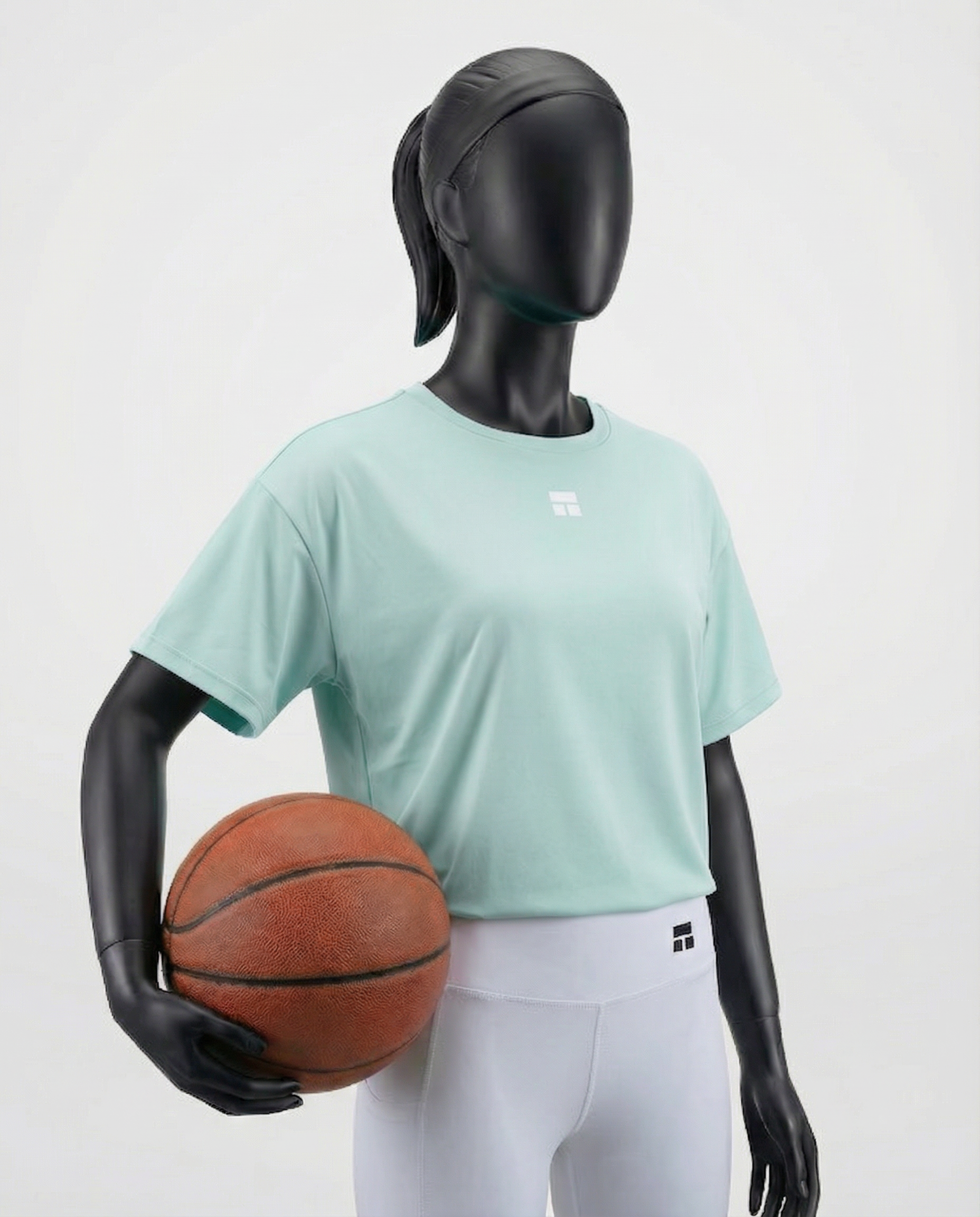 Mannequin wearing an oversized light green t-shirt on a plain background