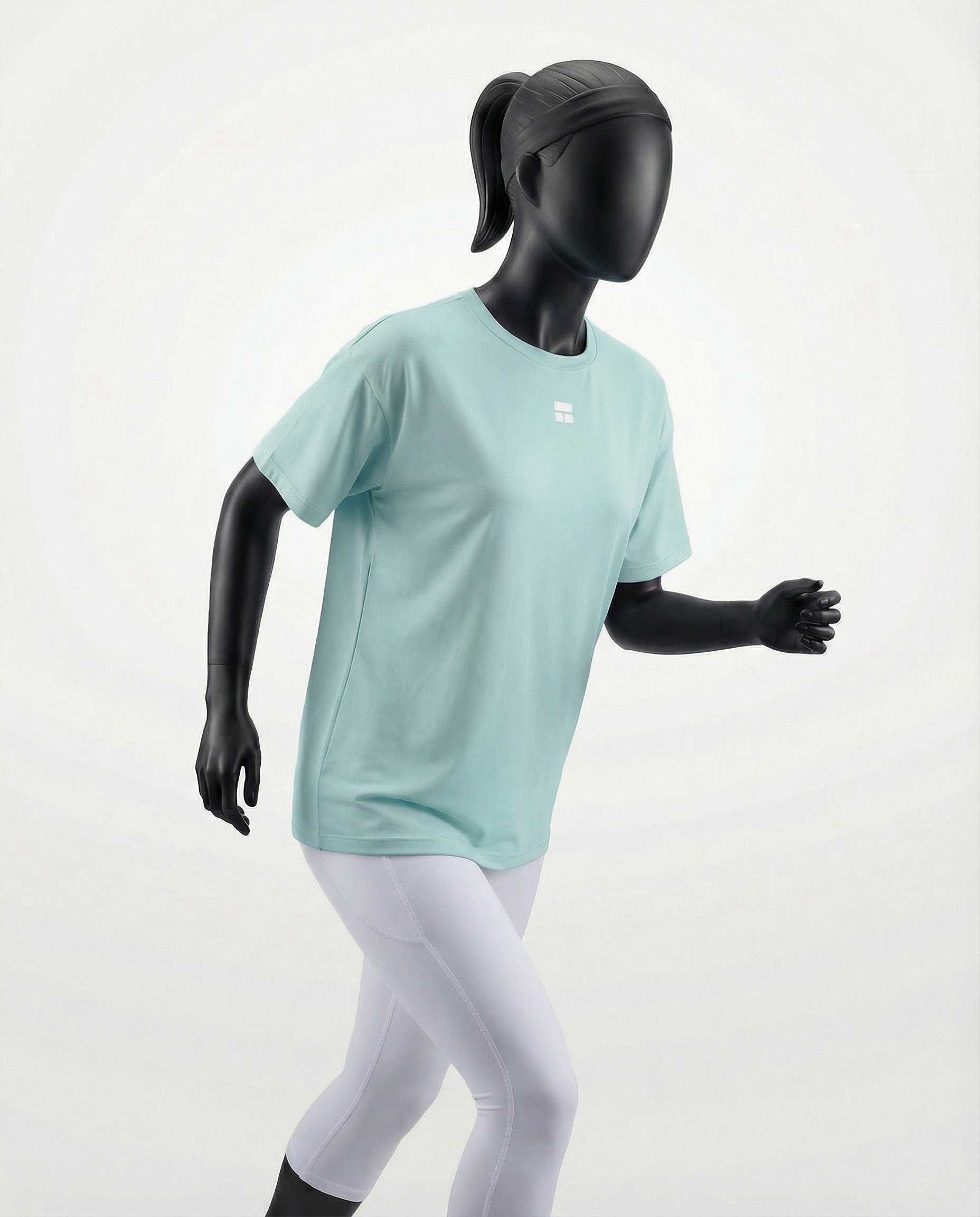 Mannequin wearing an oversized light green t-shirt on a plain background