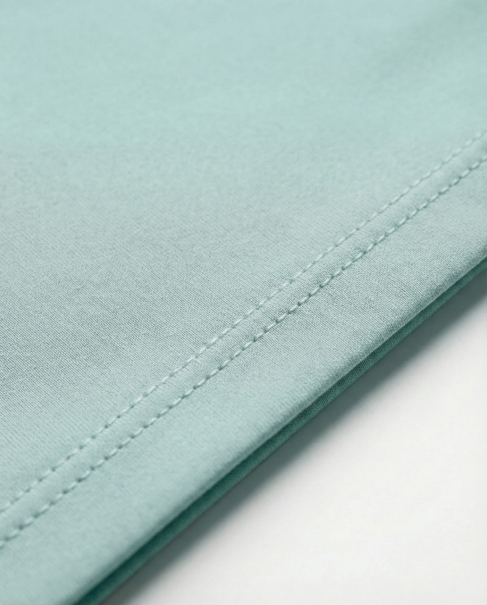 Mannequin wearing an oversized light green t-shirt on a plain background