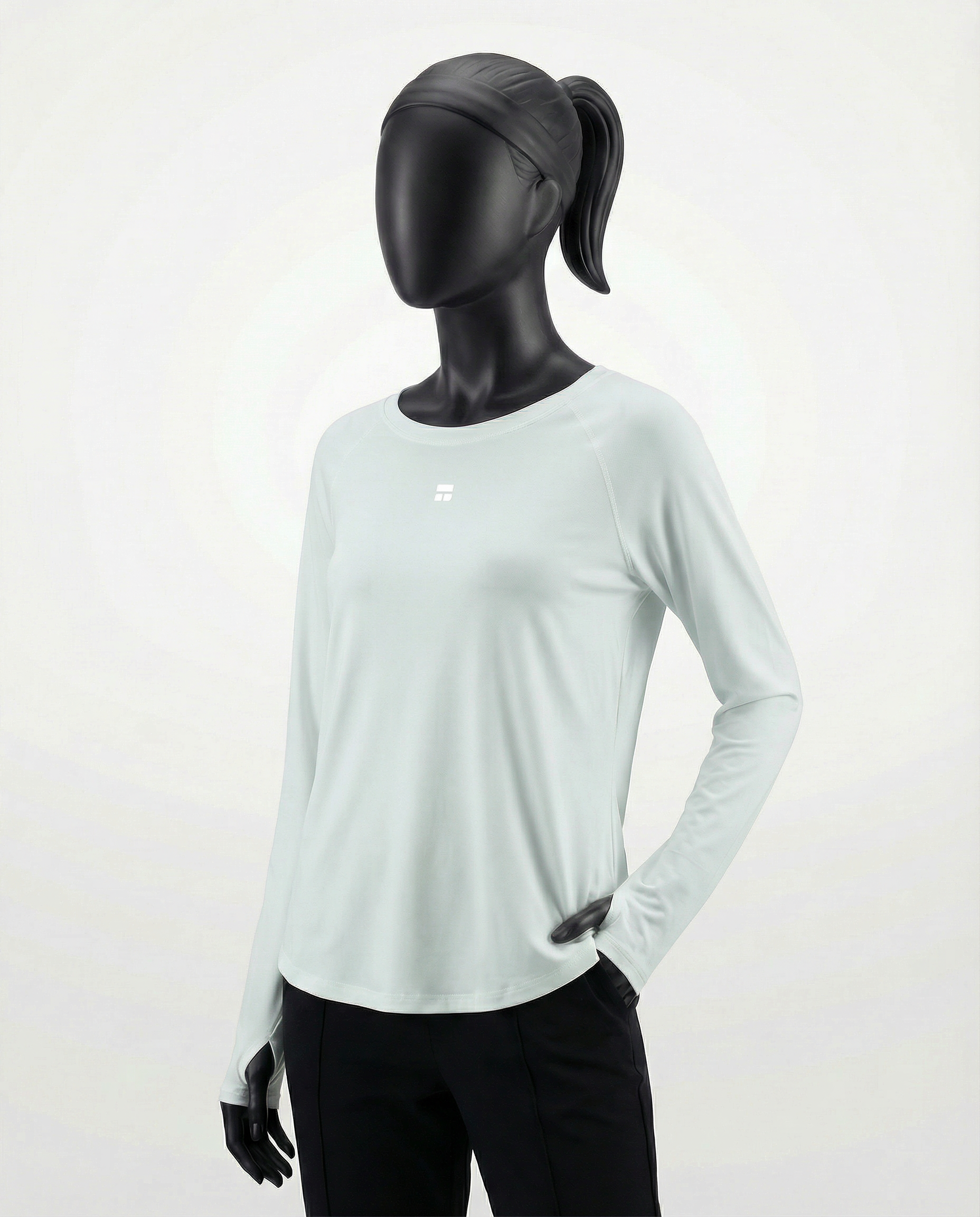 Mannequin wearing a light gray long-sleeve top with a cutout design on a white background