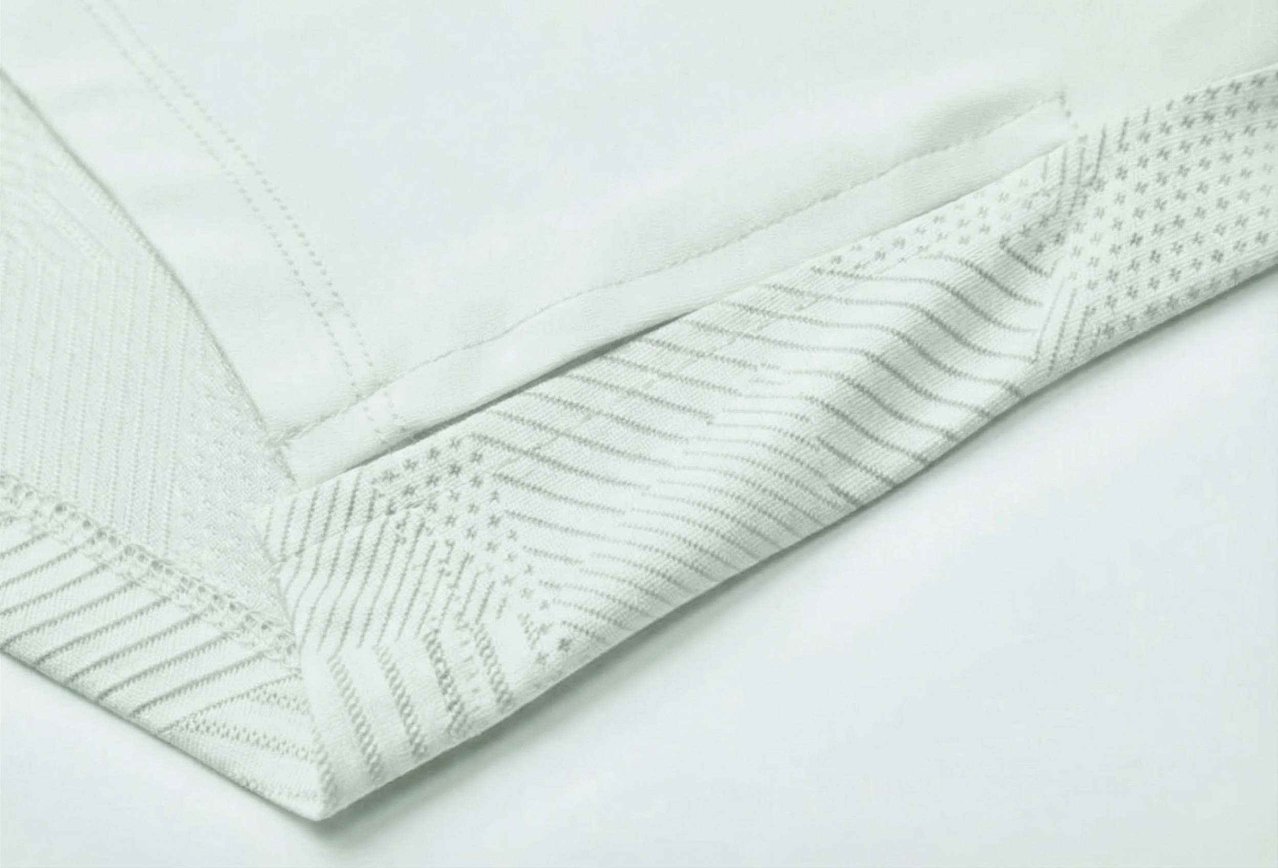 Mannequin wearing a light gray long-sleeve top with a cutout design on a white background