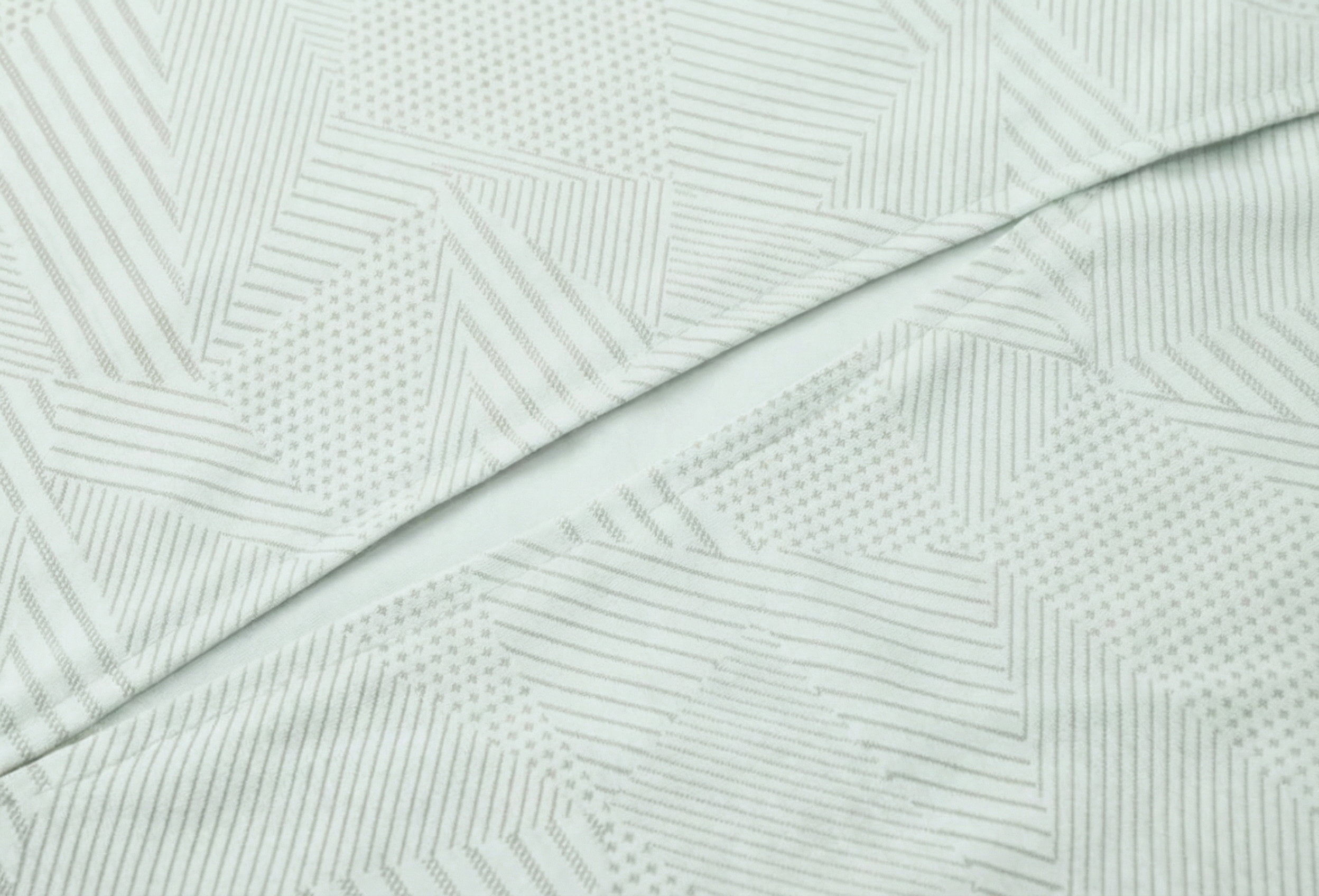 Mannequin wearing a light gray long-sleeve top with a cutout design on a white background