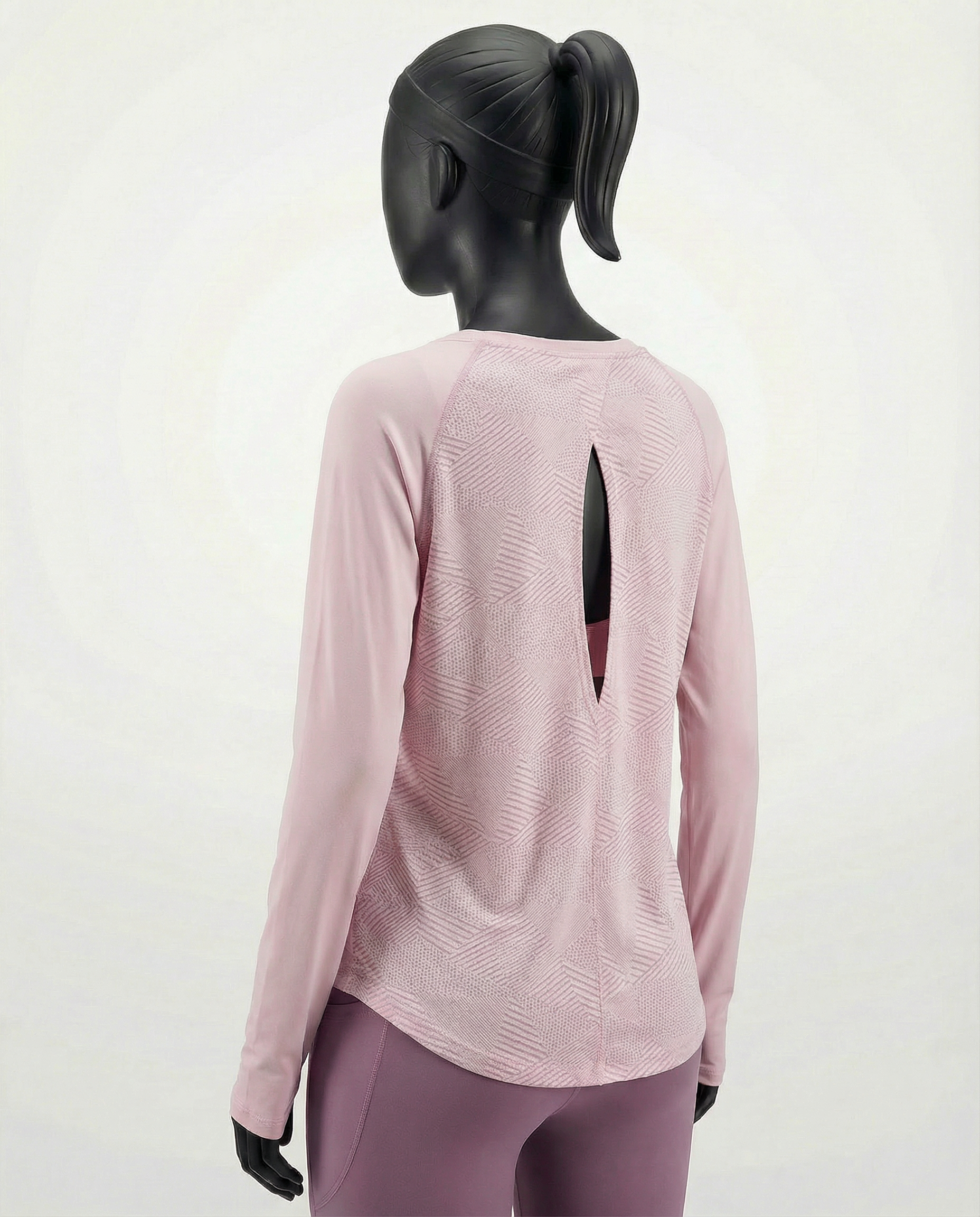 Mannequin wearing a pink long-sleeve top with a cut-out design on a white background