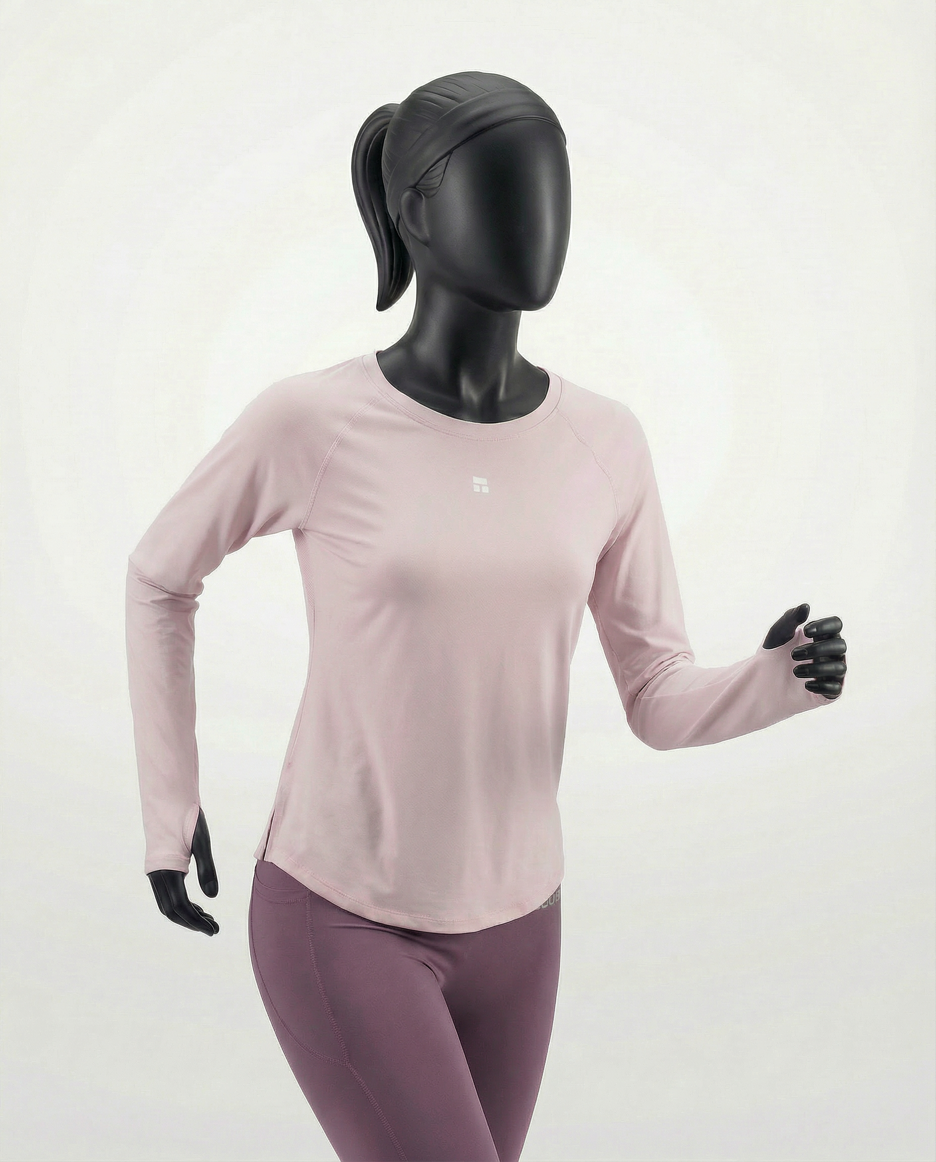 Mannequin wearing a pink long-sleeve top with a cut-out design on a white background