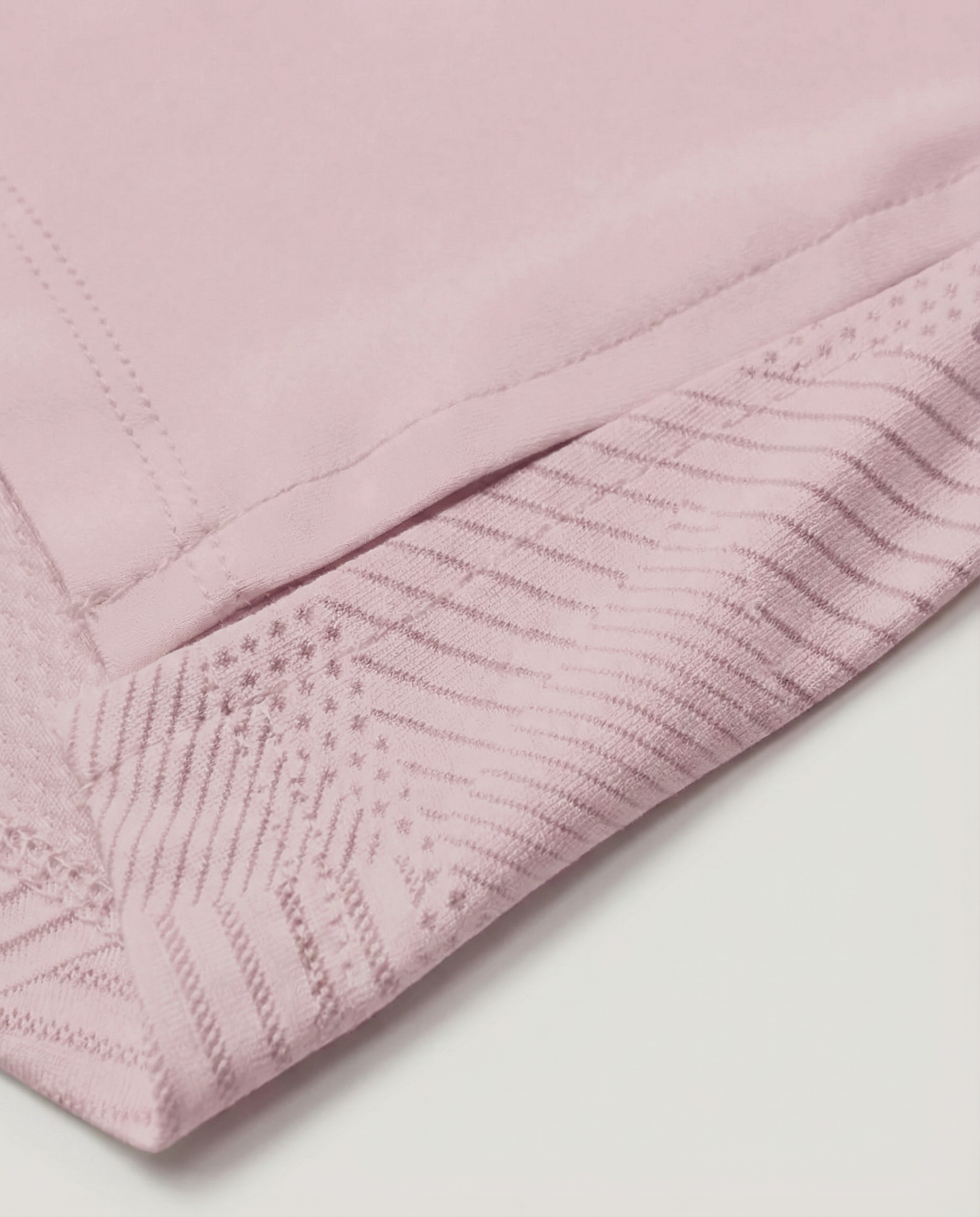 Mannequin wearing a pink long-sleeve top with a cut-out design on a white background