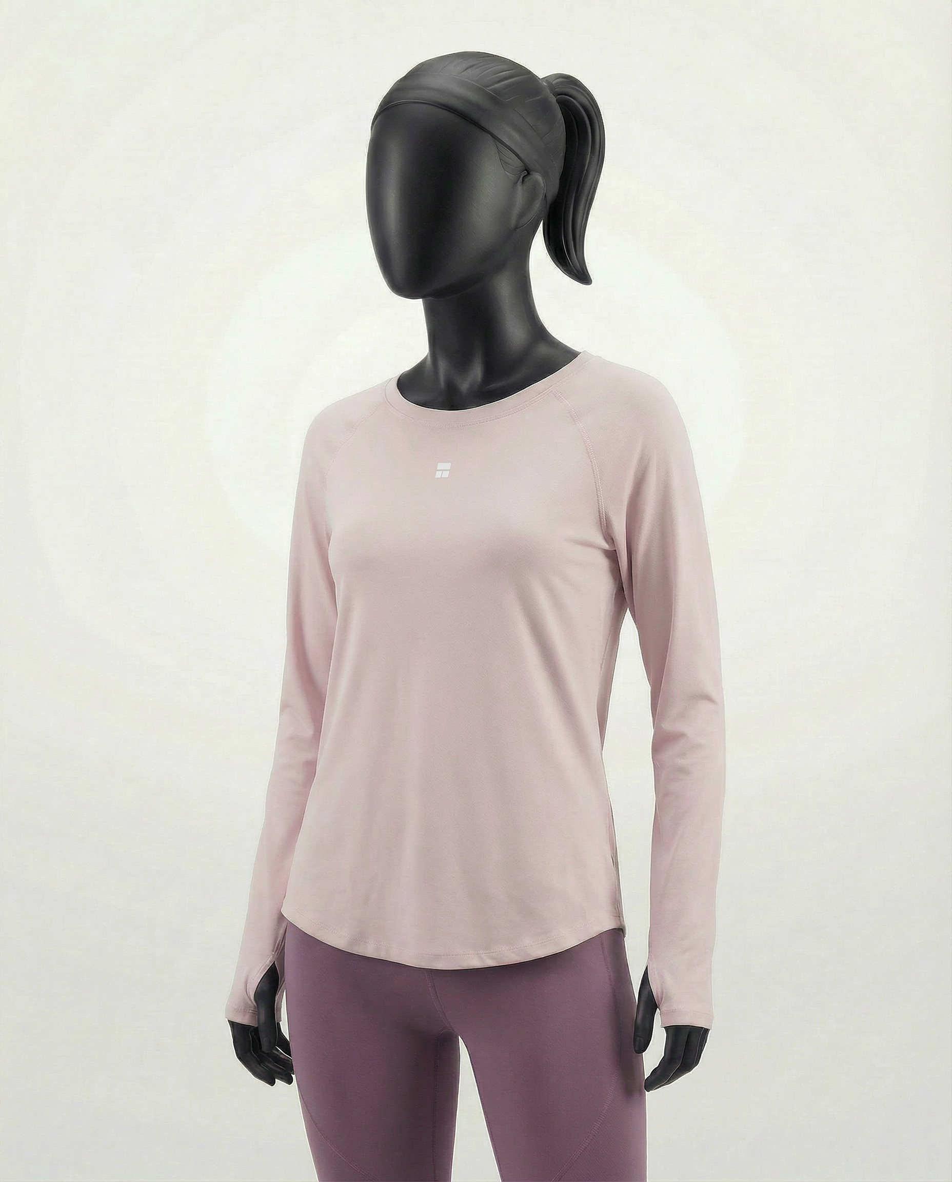 Mannequin wearing a pink long-sleeve top with a cut-out design on a white background