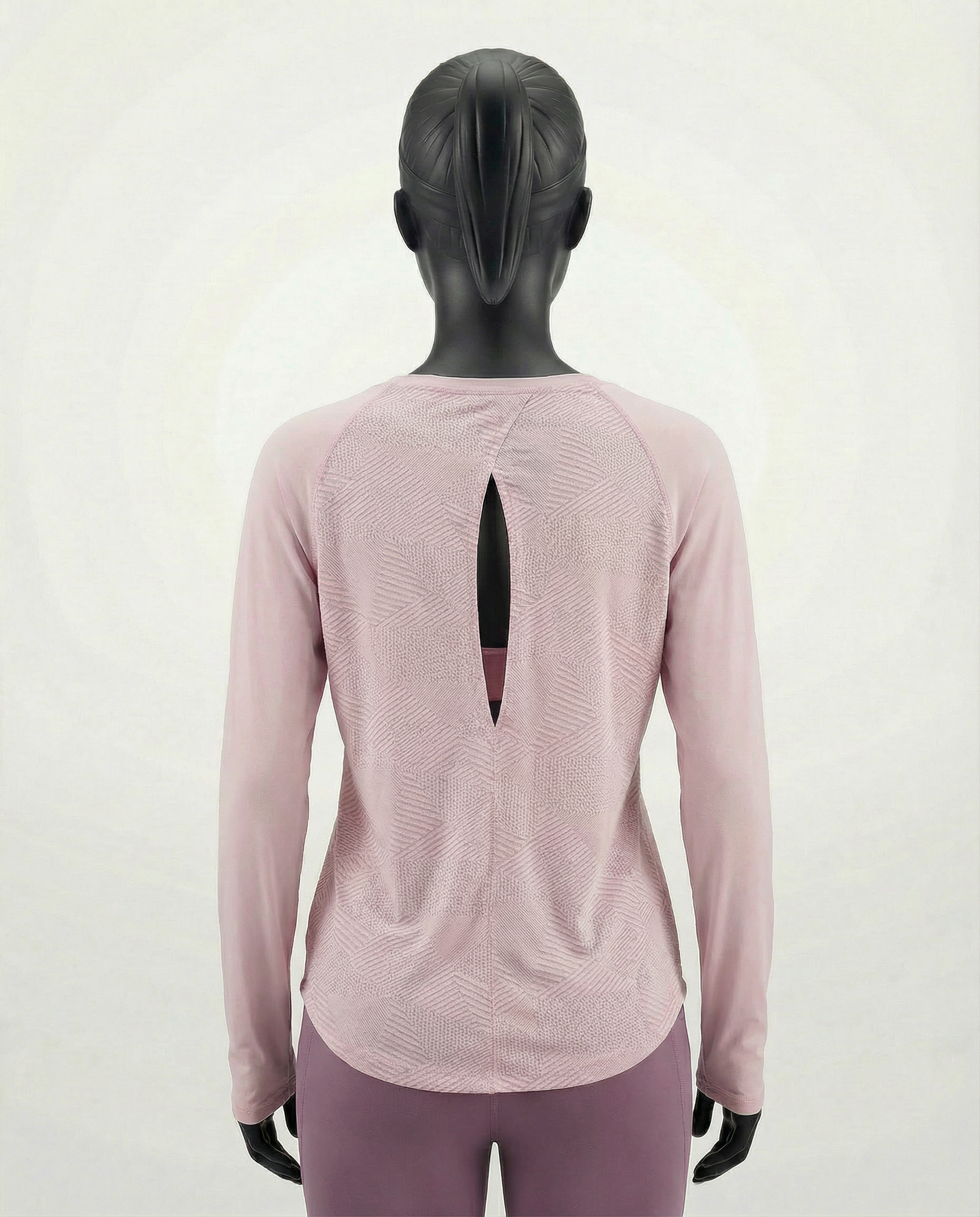 Mannequin wearing a pink long-sleeve top with a cut-out design on a white background