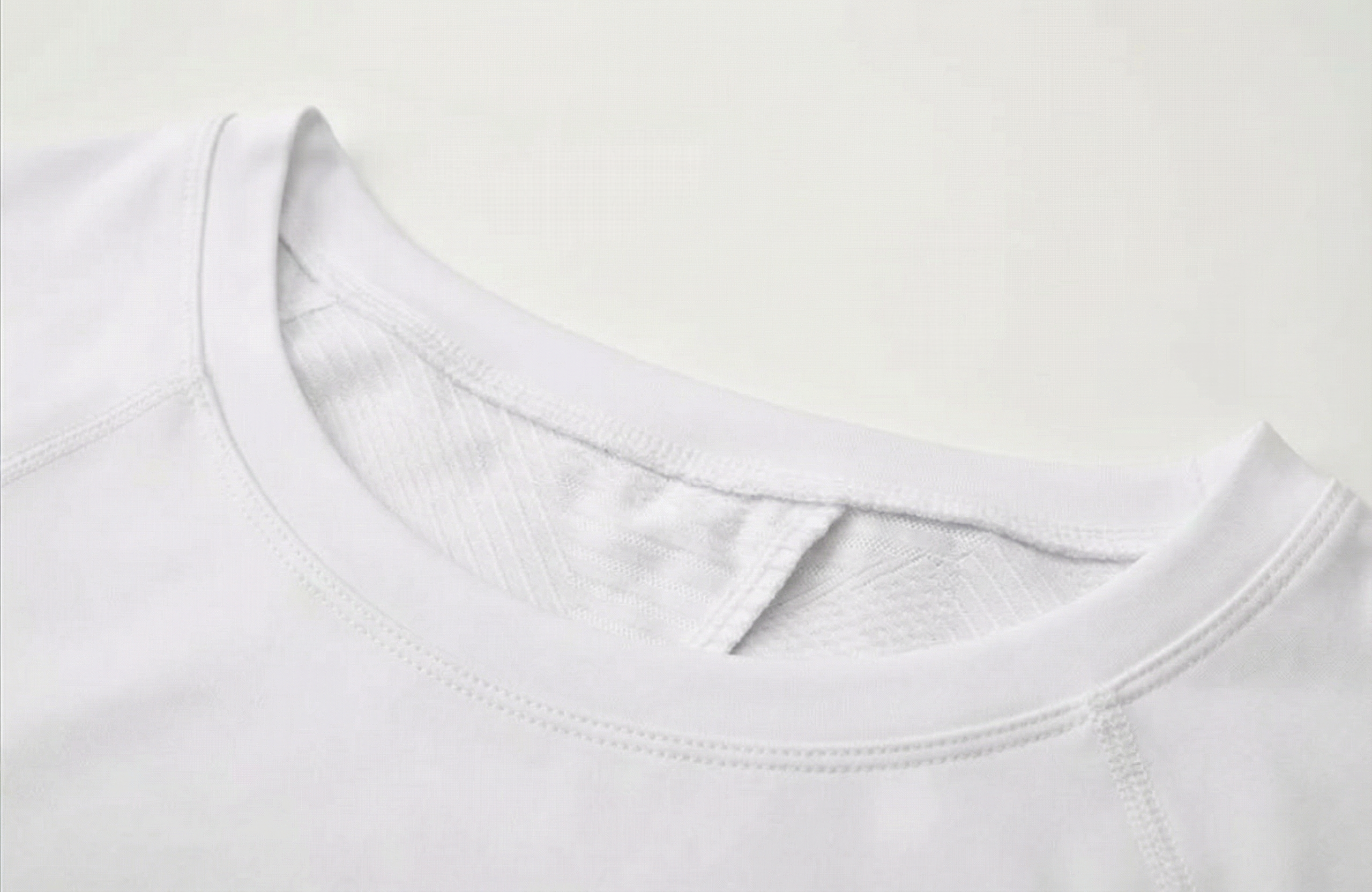 Mannequin wearing a white long-sleeve top with a cutout design on a white background