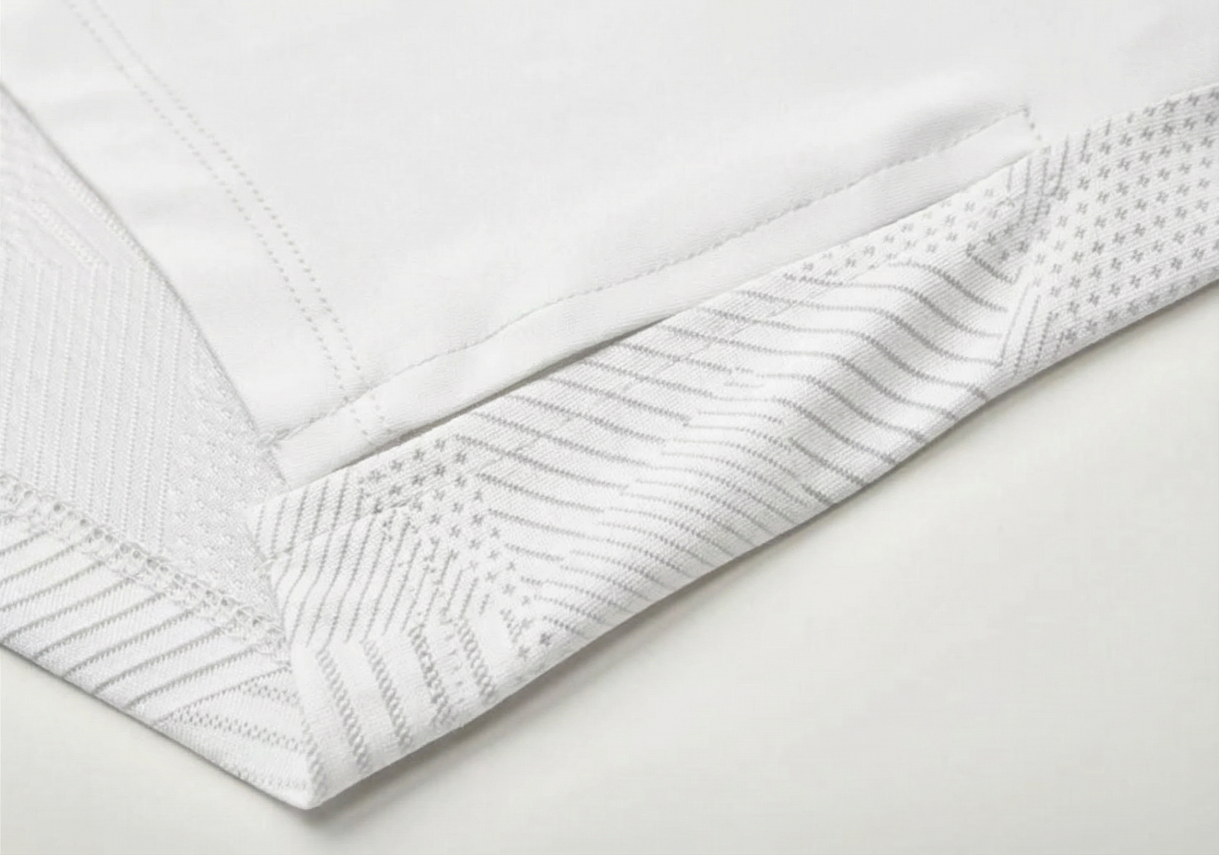 Mannequin wearing a white long-sleeve top with a cutout design on a white background