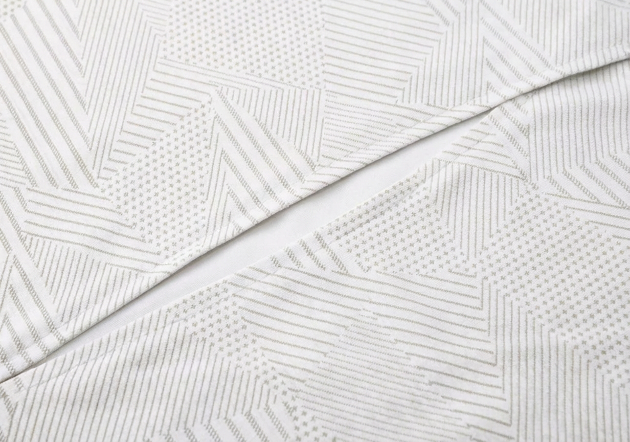 Mannequin wearing a white long-sleeve top with a cutout design on a white background