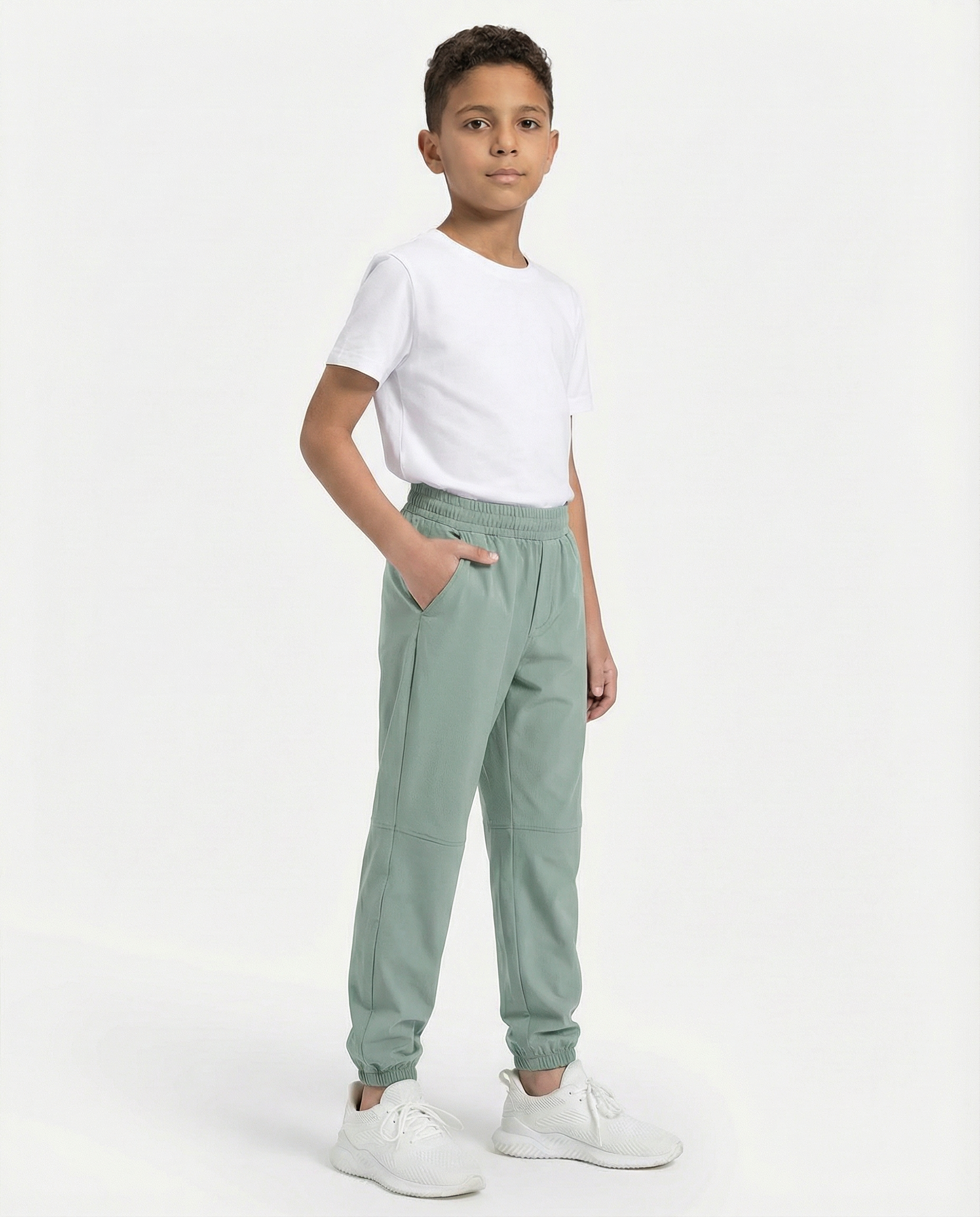Child wearing a white t-shirt and light green pants on a white background
Courts Sport