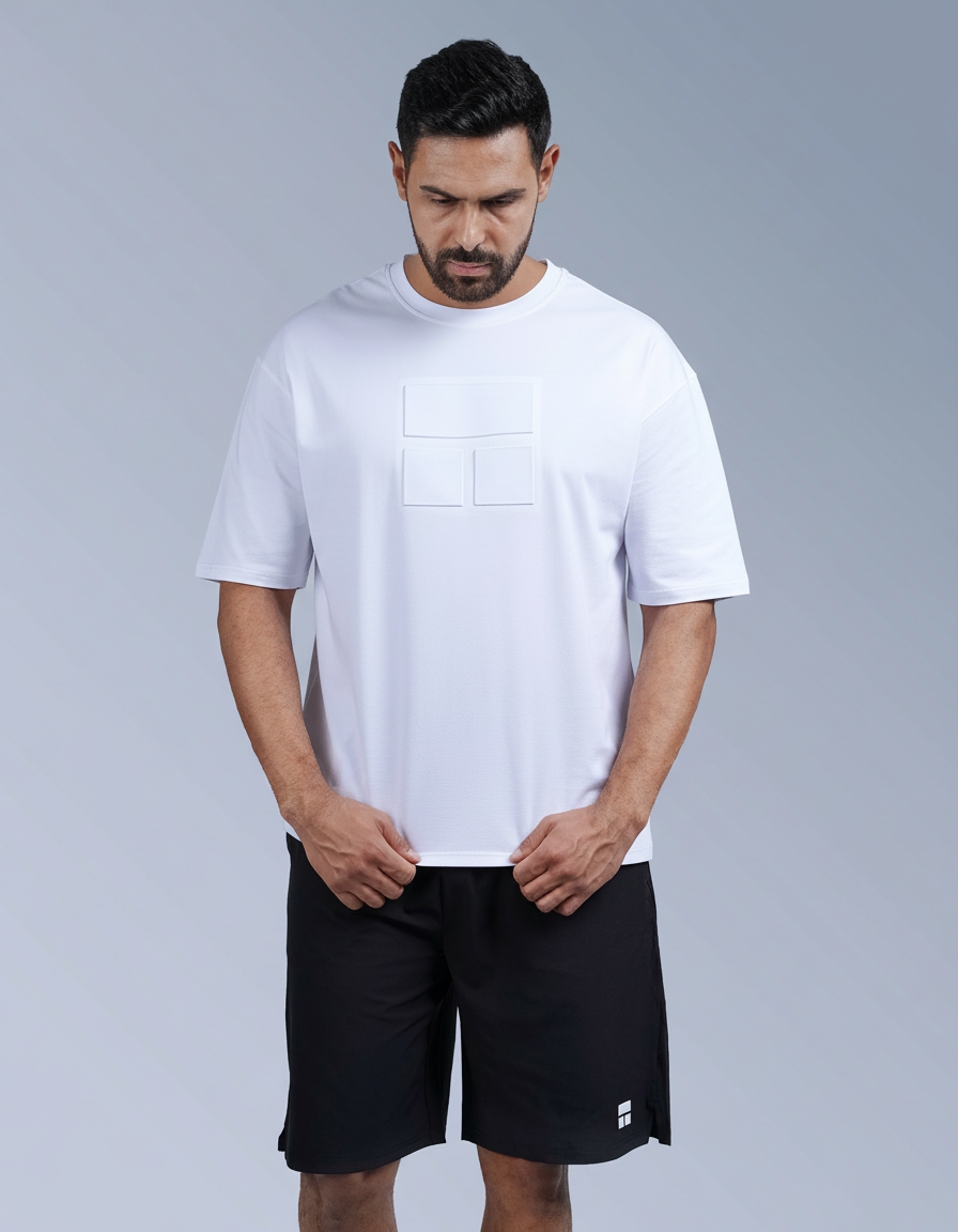 Man wearing a white t-shirt and black shorts on a gray background