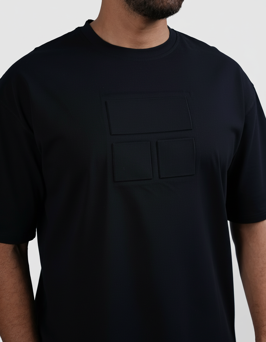 Man wearing a black t-shirt and white shorts on a light gray background