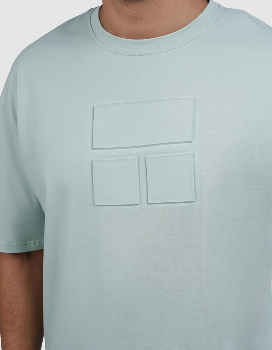 Man wearing a light blue t-shirt and black shorts on a white background