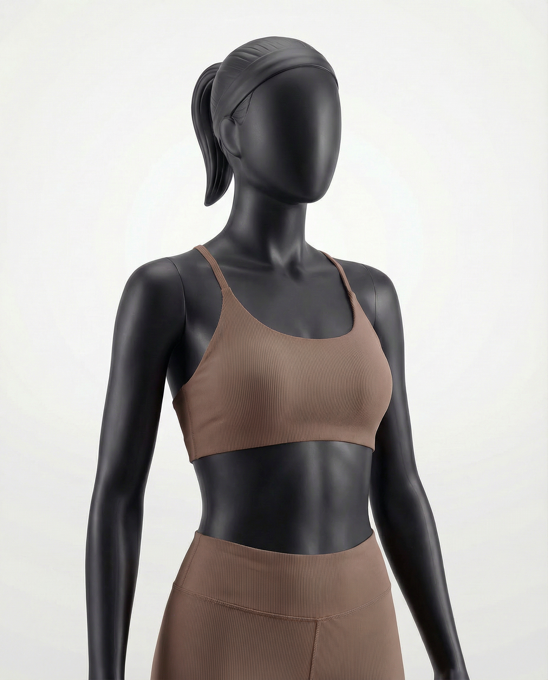 Mannequin wearing a brown sports bra and leggings on a white background
#color_light-brown