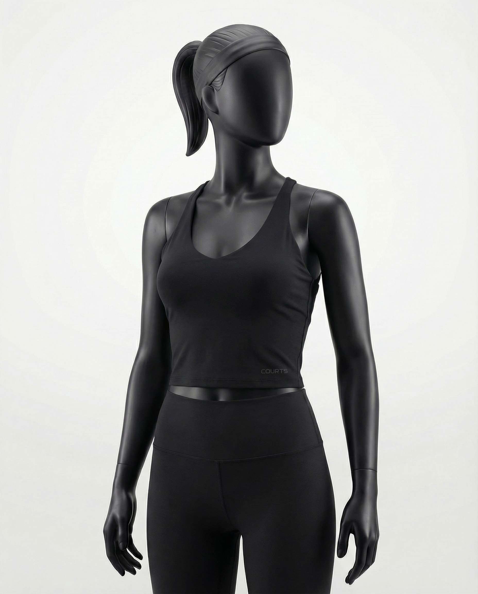 Courts black athletic crop top and leggings on a mannequin against a white background
#color_black