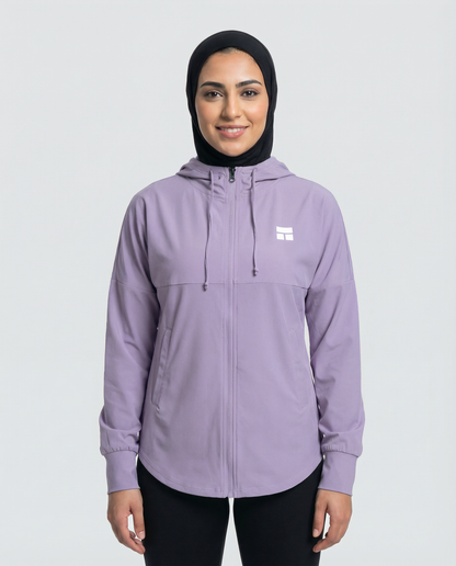 Woman wearing a purple hoodie with a brand logo on a white background
