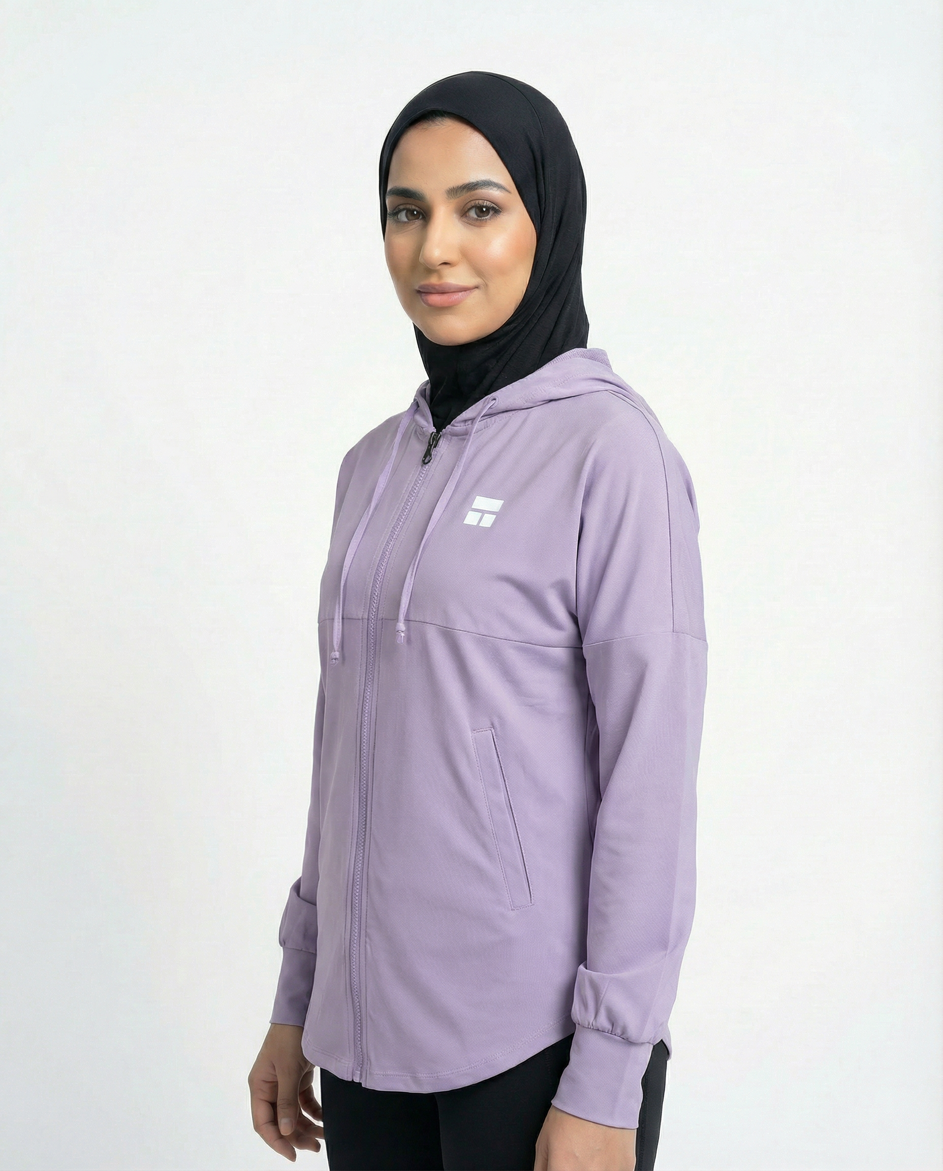 Woman wearing a purple hoodie with a brand logo on a white background
