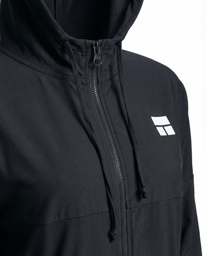 Person wearing a black hooded jacket with a logo on a white background
