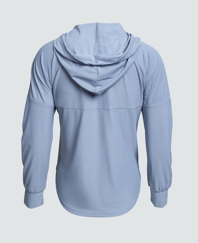 Woman wearing a light blue jacket with a logo on a white background
