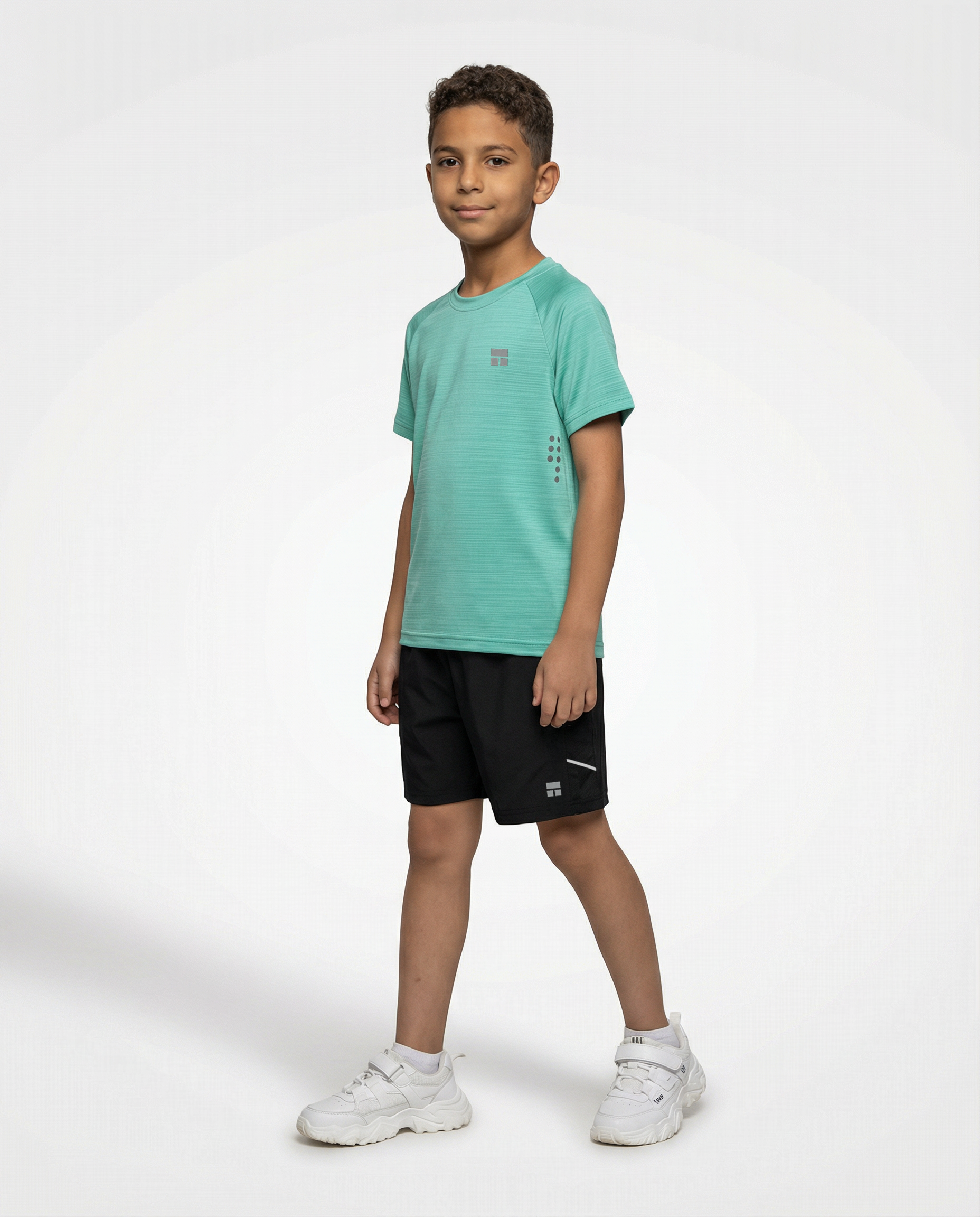 Child wearing a Courts green t-shirt and black shorts on a white background
#color_mint-green