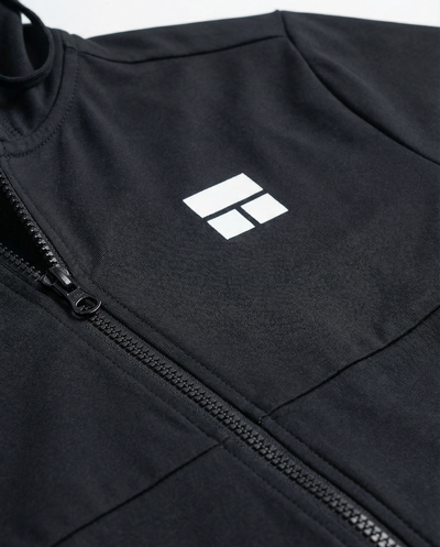 Person wearing a black hooded jacket with a logo on a white background
