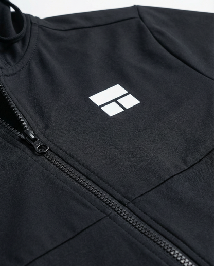 Person wearing a black hooded jacket with a logo on a white background
