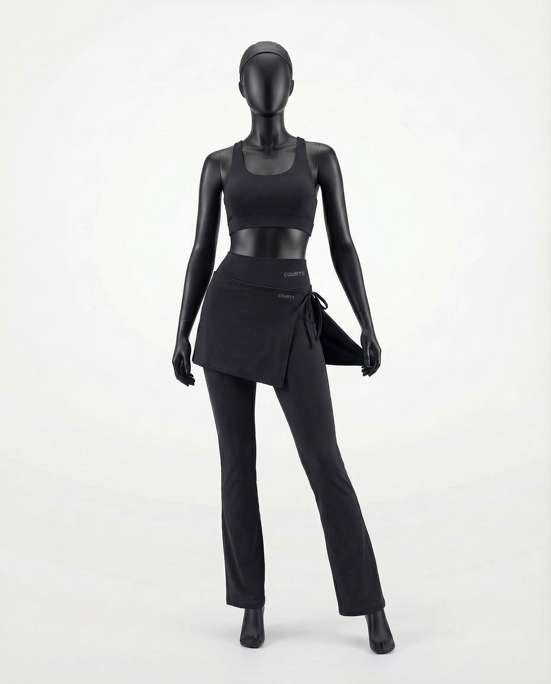 Mannequin wearing a black skirt and pants with 'Courts' branding on a white background
#color_black