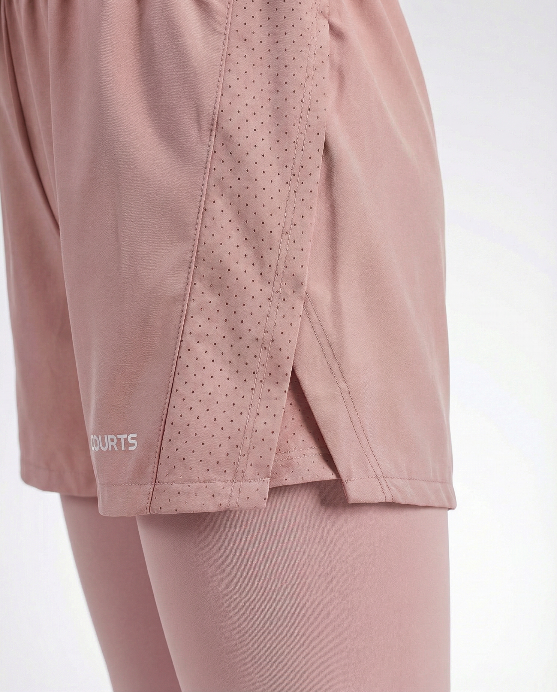 Mannequin wearing pink athletic shorts and leggings with a white background
#color_pink