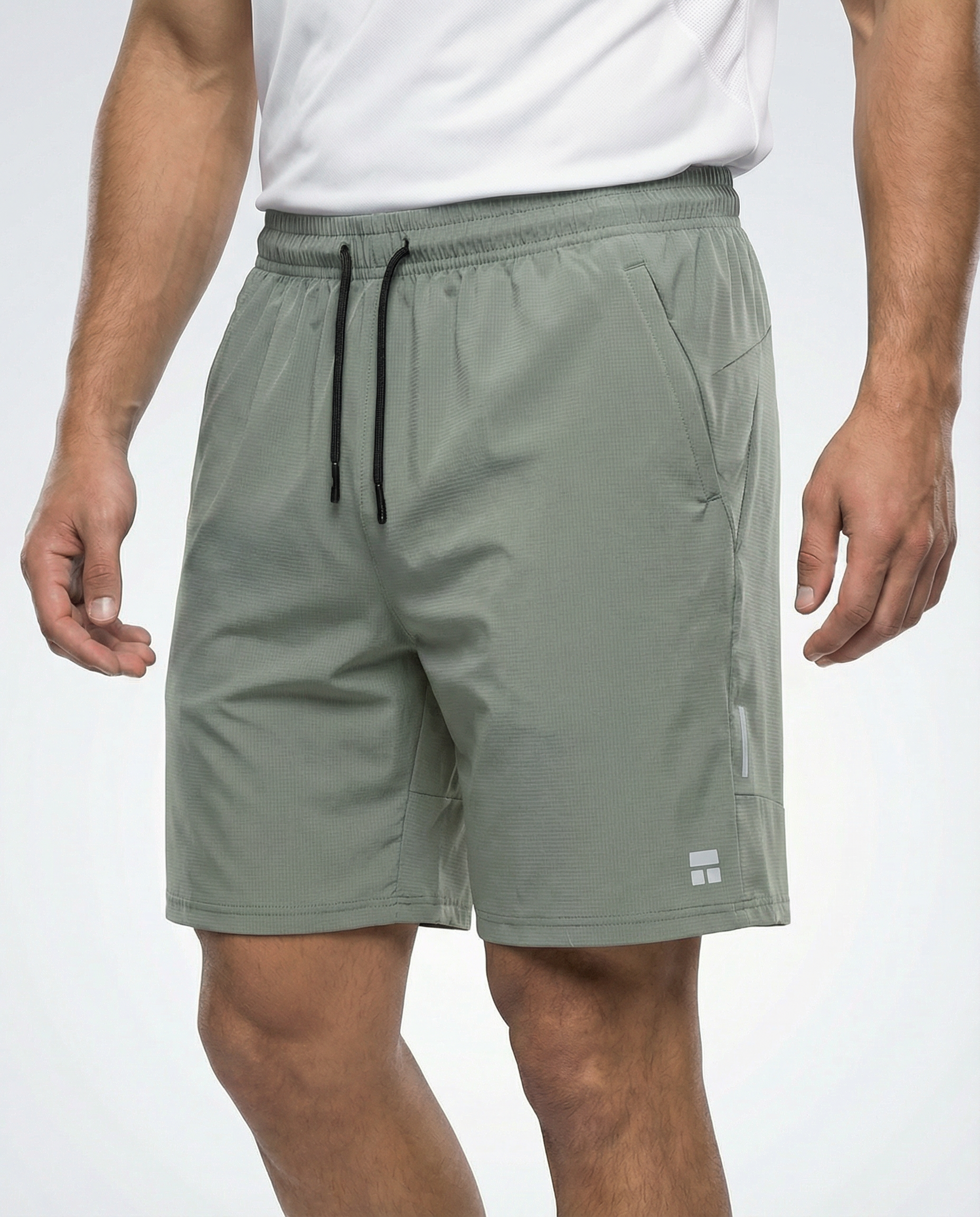 Person wearing Courts sport army green shorts with a white background 
#color_army-green