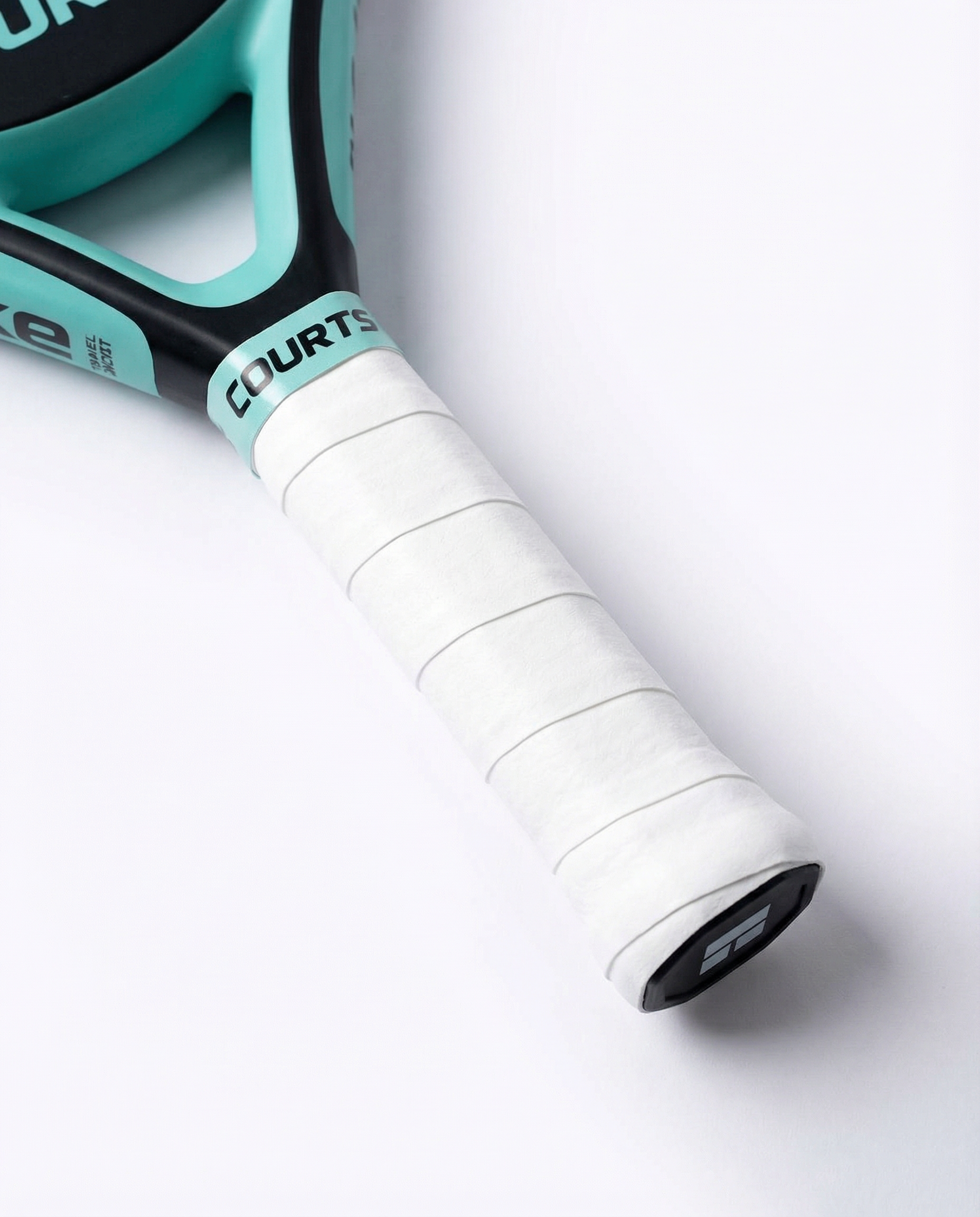 black padel and tennis racket handle with white grip and 'COURTS' branding on a white background
