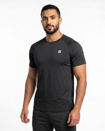 Man wearing a black athletic outfit with a logo on a white background
