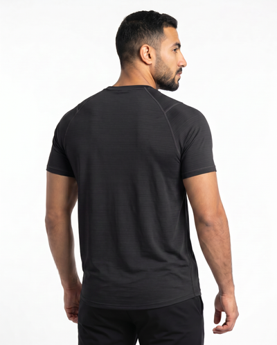 Man wearing a black athletic outfit with a logo on a white background
