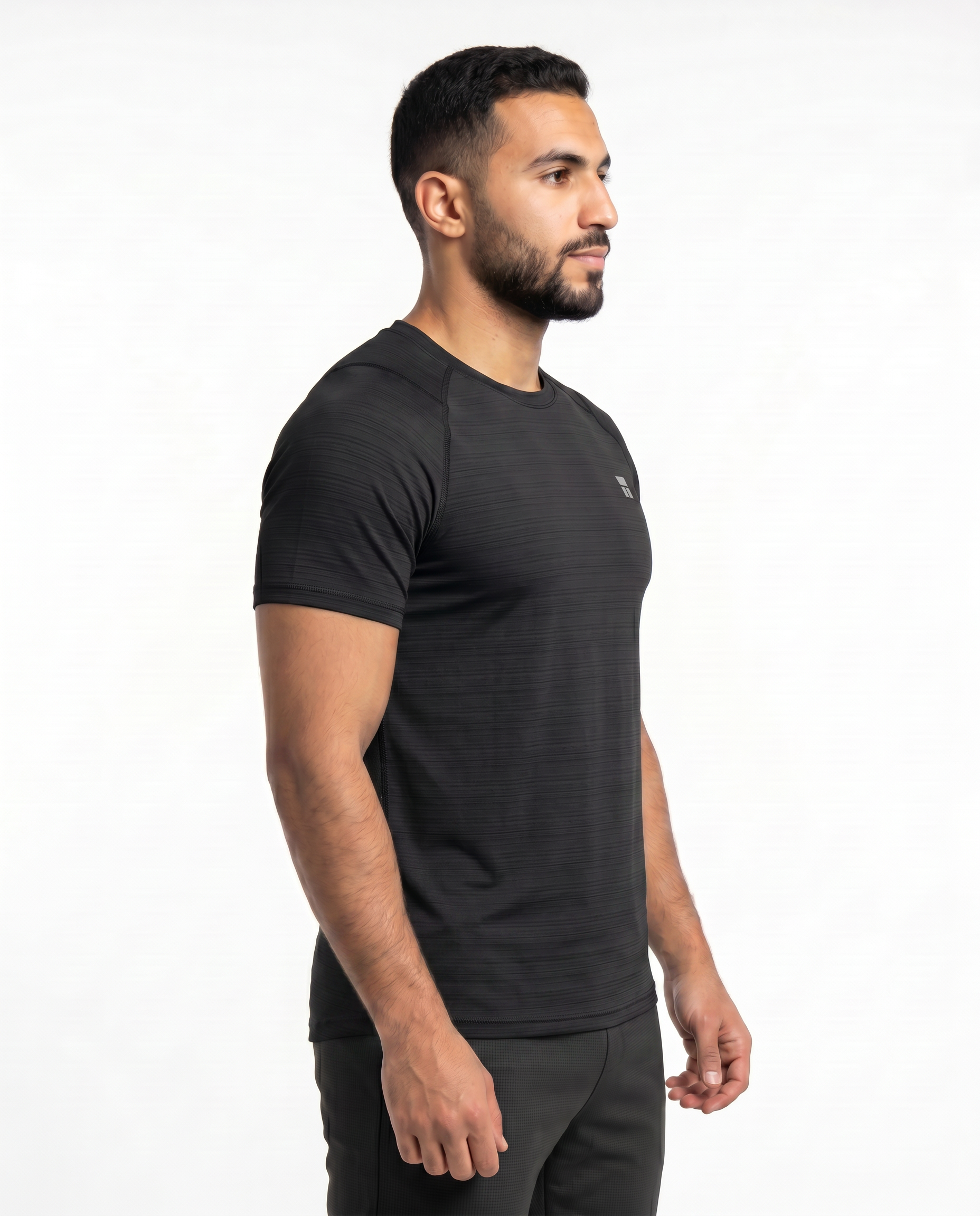 Man wearing a black athletic outfit with a logo on a white background
