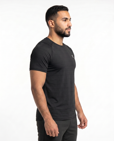 Man wearing a black athletic outfit with a logo on a white background

