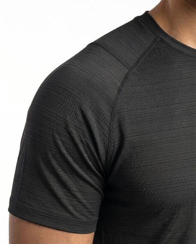 Man wearing a black athletic outfit with a logo on a white background
