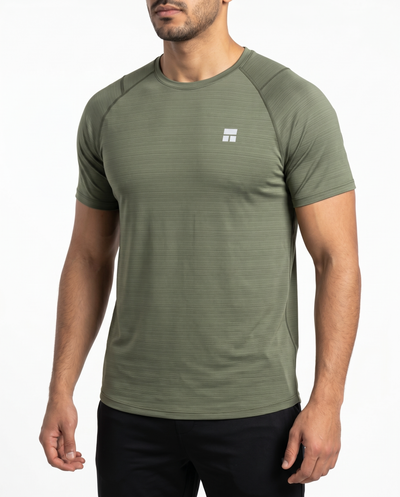 Man wearing an olive green athletic shirt on a white background
