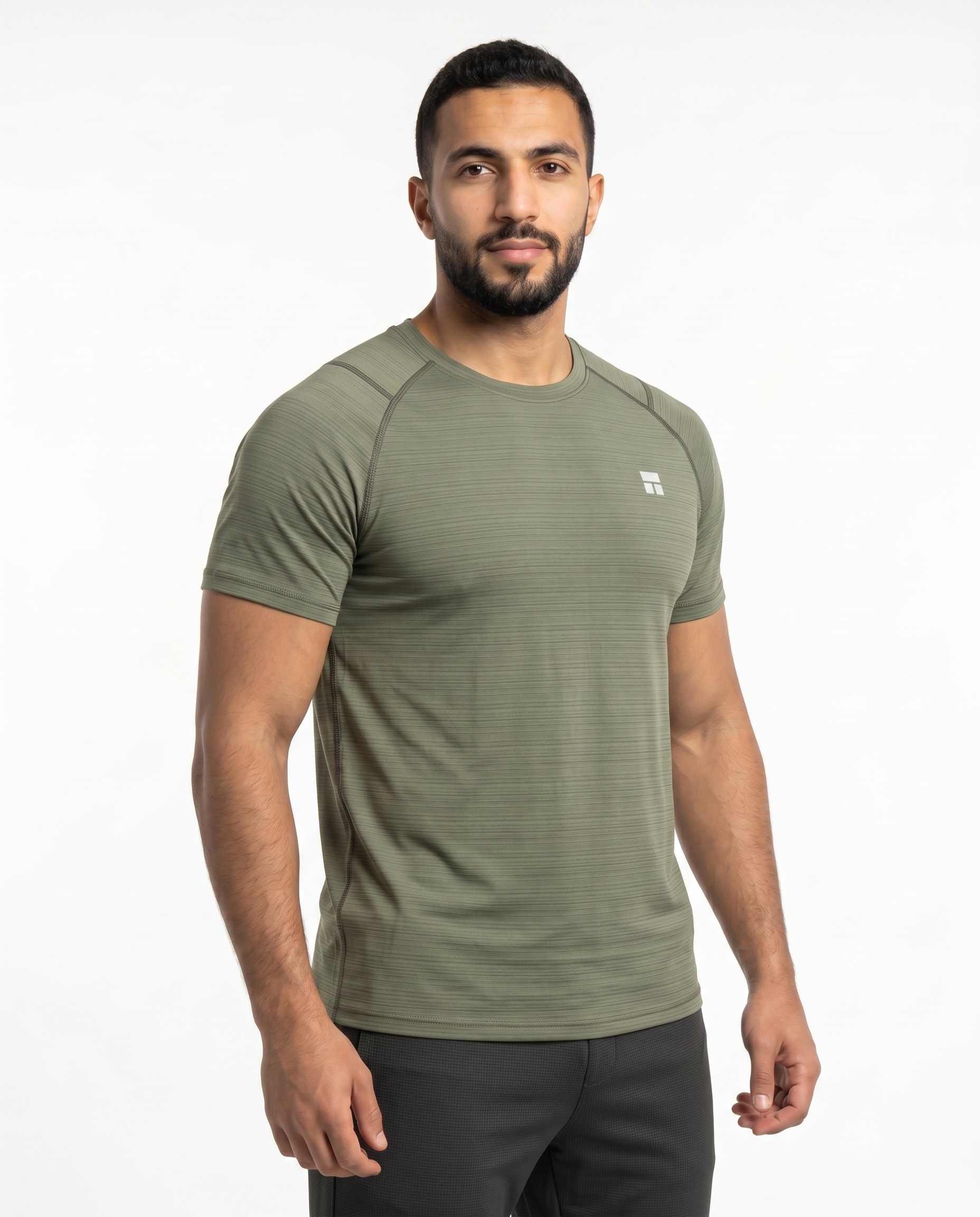 Man wearing an olive green athletic shirt on a white background
