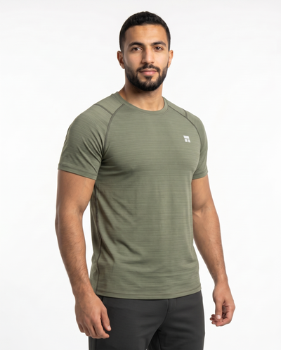 Man wearing an olive green athletic shirt on a white background
