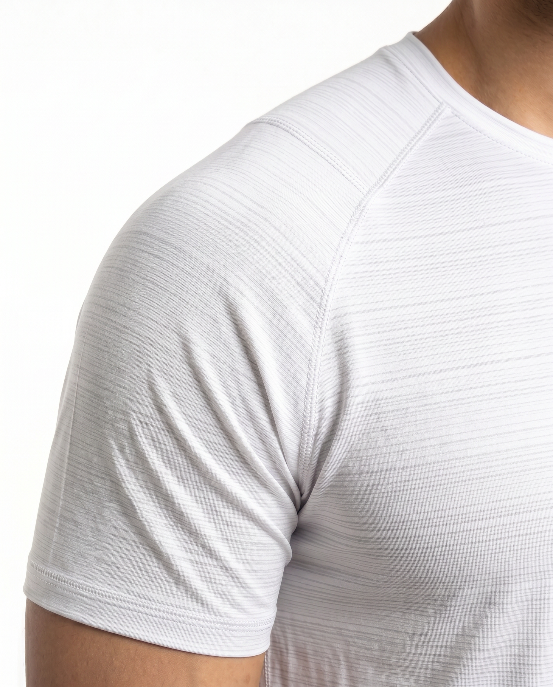 Man wearing a white t-shirt with a small logo on a white background
