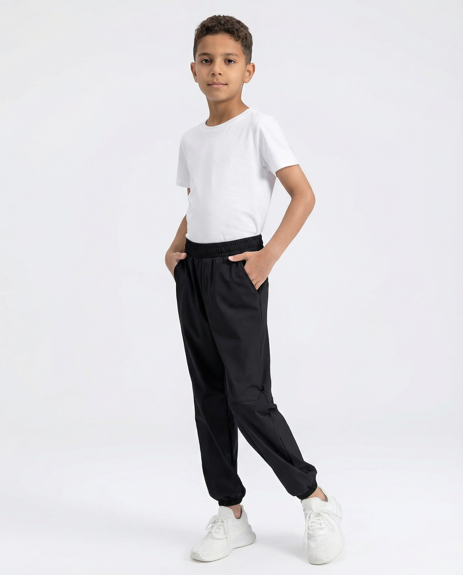 Person wearing black jogger pants and white sneakers on a white background
Courts Sport
#color_black