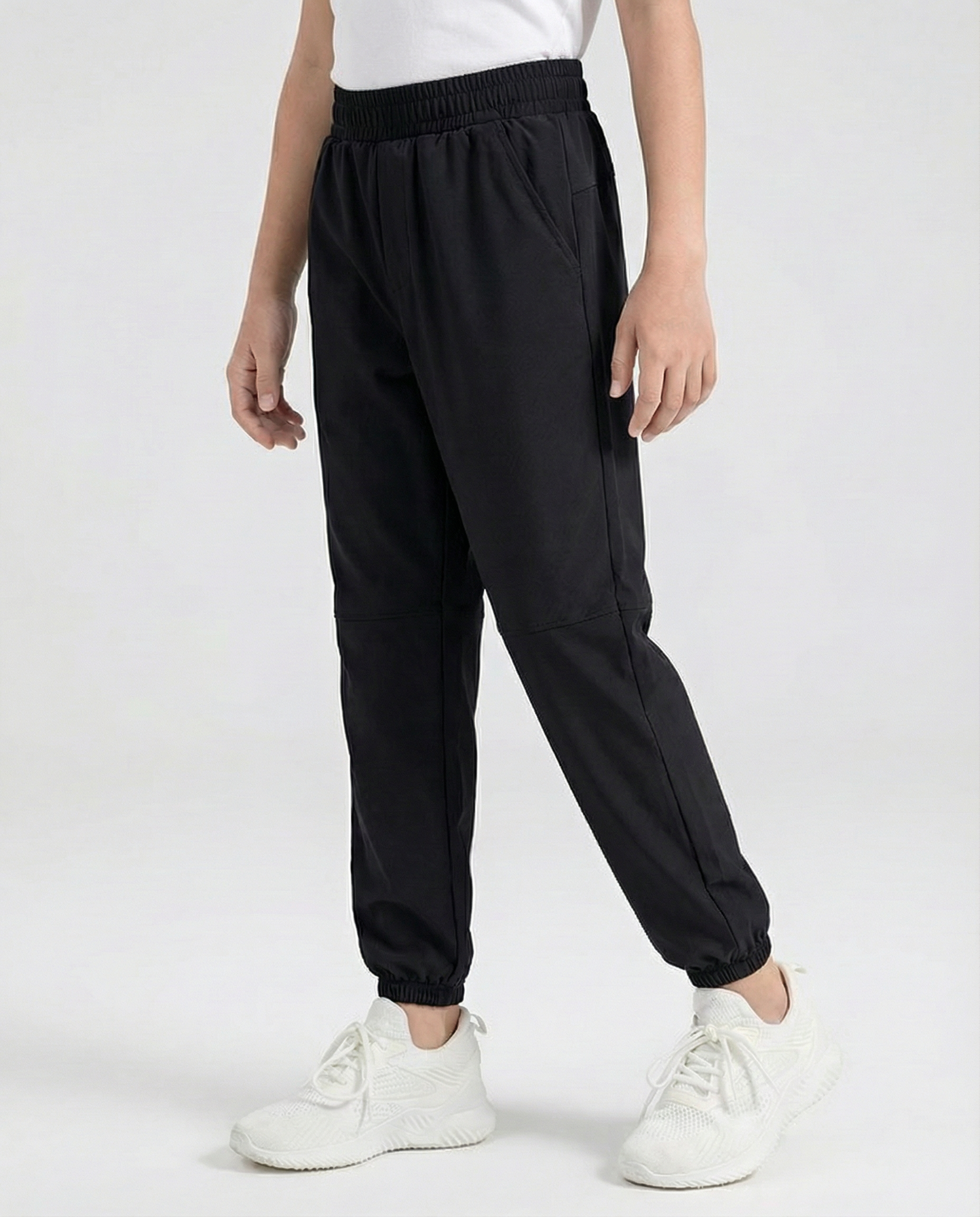 Person wearing black jogger pants and white sneakers on a white background
Courts Sport
#color_black