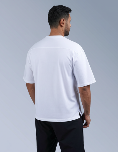 Man wearing a white t-shirt and black shorts on a gray background

