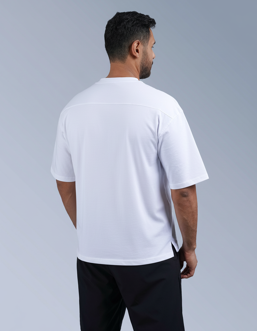 Man wearing a white t-shirt and black shorts on a gray background

