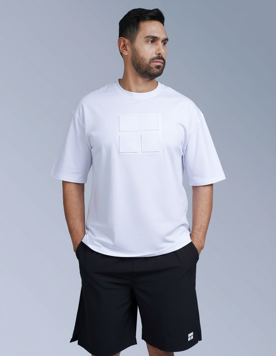 Man wearing a white t-shirt and black shorts on a gray background

