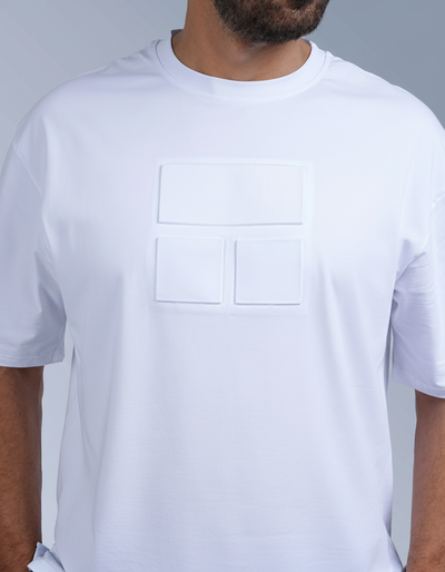 Man wearing a white t-shirt and black shorts on a gray background

