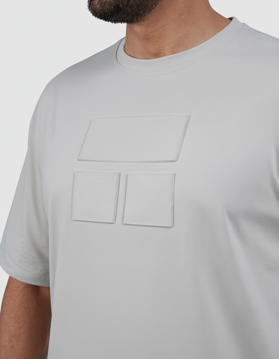 Man wearing a gray t-shirt and black shorts on a white background
